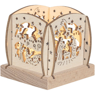 Kleiner Holz‑Kerzenhalter mit filigranen Glocken‑Ausschnitten, Sternmotiven und warm leuchtendem Innenbereich; gestaltet für ein einzelnes Teelicht.