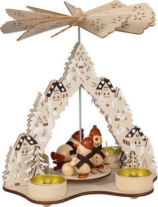Weihnachtspyramide aus Holz für 4 Teelichte mit lustigen Schneemännern, verschneiten Tannenbäumen, Winterhäusern und filigranem Flügelrad, 23 cm.