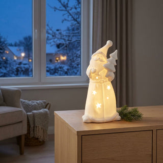 LED Weihnachtsmann „Tannenbaum“ (15 cm) in Weiß, warmweiß beleuchtet, mit ausgestanzten Sternmotiven und integriertem Tannenbaum, als stimmungsvolle Tisch- oder Fensterdekoration in gemütlicher Winteratmosphäre.