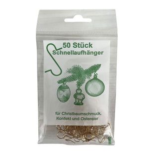 Transparenter Kunststoffbeutel mit 50 goldfarbenen Schnellaufhängern für Baumschmuck; auf dem Etikett grüne Zeichnungen eines Aufhängers sowie Christbaumkugeln und ein Zweig, darunter der Text „50 Stück Schnellaufhänger“ und „für Christbaumschmuck, Konfekt und Ostereier“.