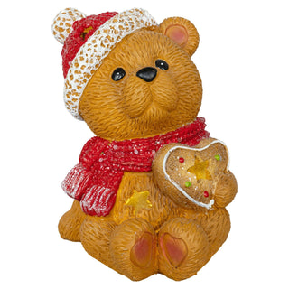 Leuchtende LED-Dekoration in Form eines sitzenden Teddybären, der ein rotes Herz in den Pfoten hält. Die Figur ist 15,5 cm hoch, batteriebetrieben und mit einer Timerfunktion ausgestattet.