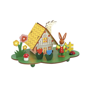 LED-Lichterhaus auf einem grünen Sockel mit bunten Blumen und einem Osterhasen