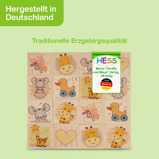 Ein Memo-Spiel mit dem Titel „Giraffe und Maus“ von HESS, bestehend aus 28 farbigen Holzplättchen mit Illustrationen von Giraffen und Mäusen. Auf der Verpackung steht „Hergestellt in Deutschland“ und „Traditionelle Erzgebirgsqualität“ sowie ein Hinweis auf die 100% deutsche Herstellung.