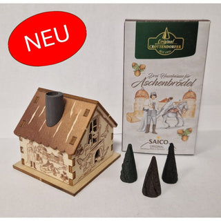 Aus unserer neuen Kollektion. Das Set besteht aus einem kleinen hölzernem Räucherhaus mit verschiedenen DEFA-Aschenbrödel-Motiven auf allen Seiten. 
Passend dazu bekommen Sie eine Packung mit 24 Räucherkerzen, um das winterliche Aroma zu genießen. Bild 1.