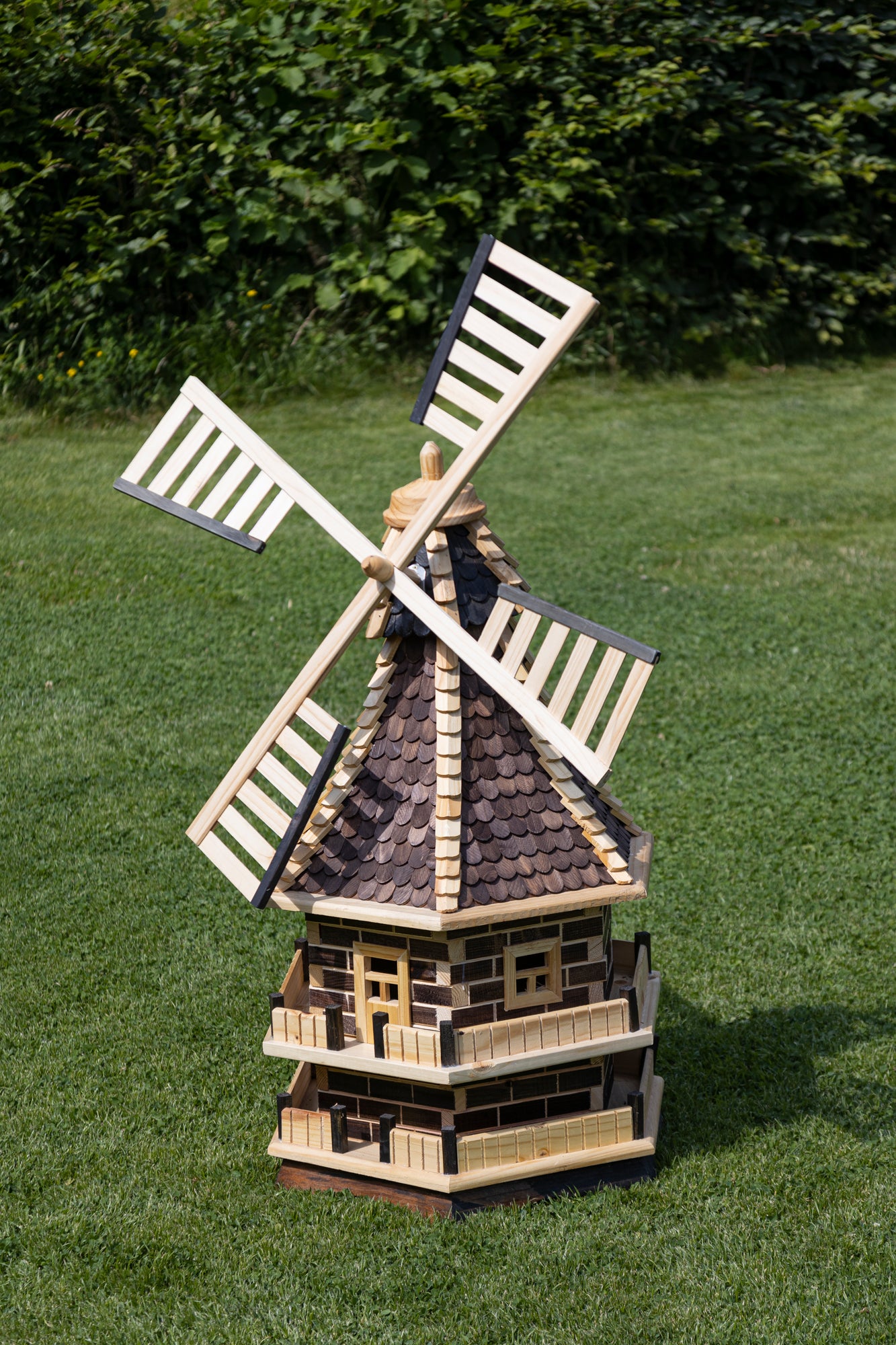 Wooden windmill, two-story, with black wooden shingle roof