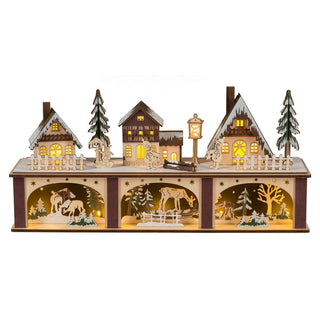 Farbiges LED Lichterhaus mit Sockel. Der beleuchtete Sockel ist dreigeteilt. Hier lässt sich eine Gruppe Rehe ganz ungestört im verschneiten Wald beobachten. Auf der oberen Ebene ruht das Auge des Betrachters auf einer friedvollen, winterlichen Stadt. Die festlich beleuchteten Fenster sorgen für Weihnachtsstimmung pur.