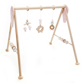 Spielbogen aus Holz, naturfarben mit rosa Elementen zum Spielen und Greifen